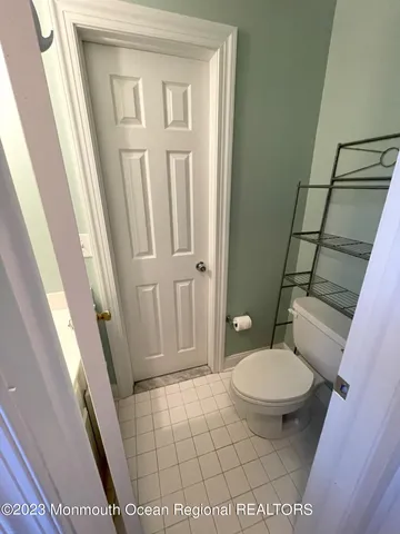 a bathroom with a sink a toilet a mirror and shower