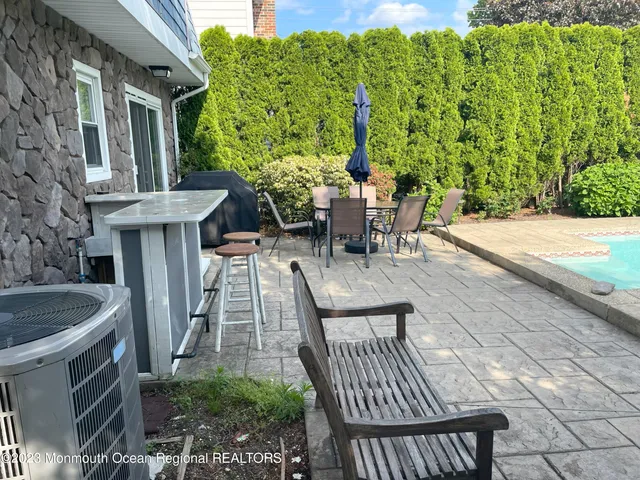 a view of a patio with table and chairs and potted plants
