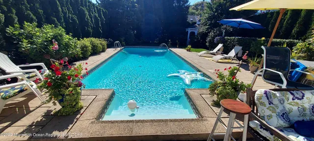 a view of a backyard with sitting area