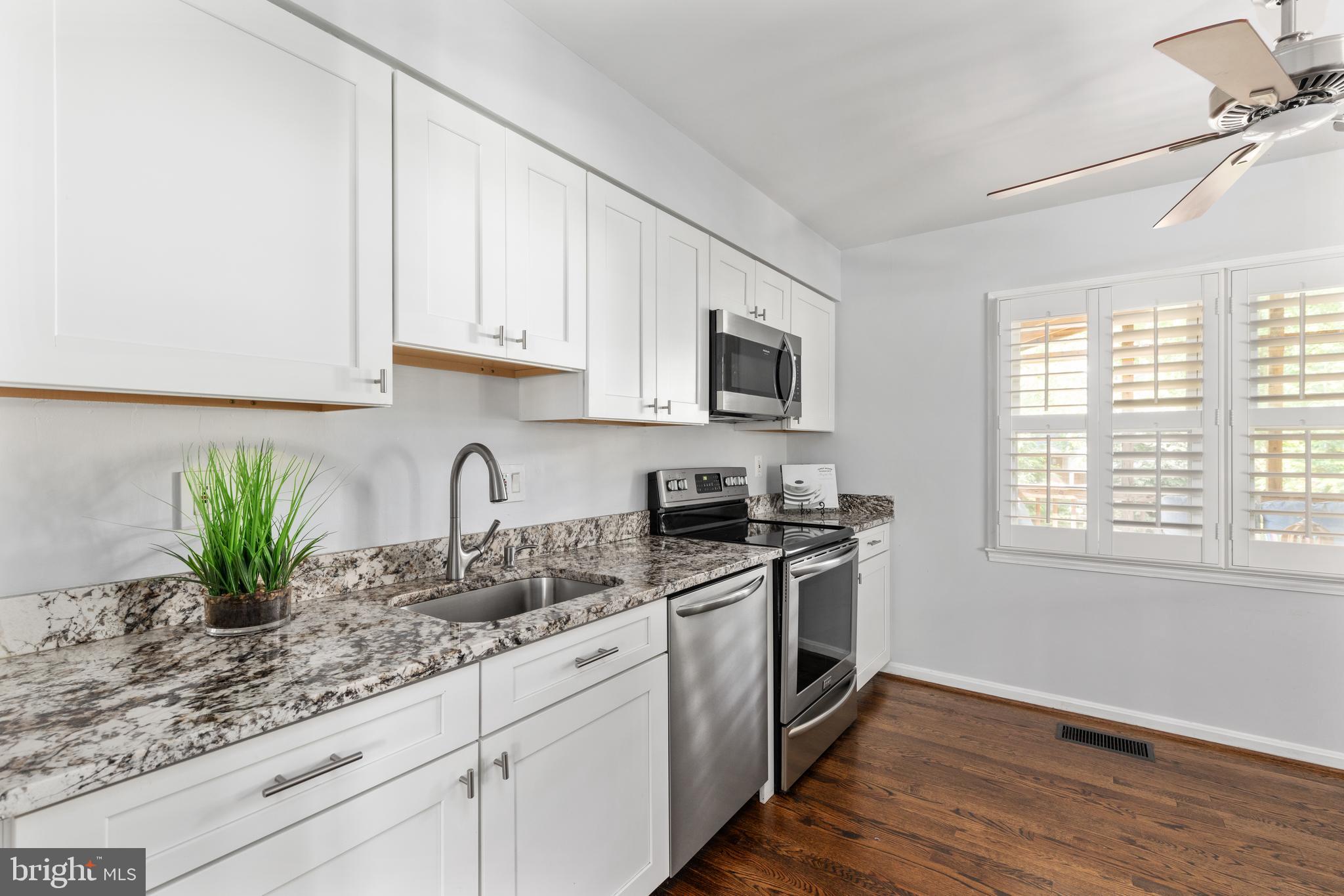 508 Fillmore Street Herndon, VA 20170 - Photo 11 of 39 a kitchen with stainless steel appliances granite countertop white cabinets a potted plant and a hard wood floor