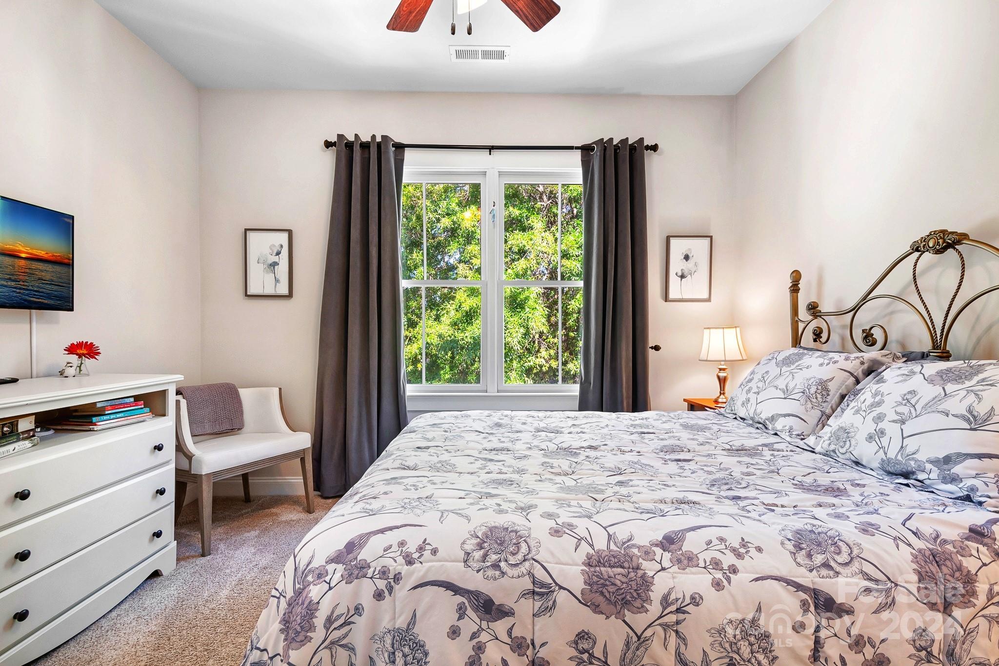 2607 Nations Commons Street Fort Mill, SC 29708 - Photo 18 of 40 a bedroom with a bed and a flat tv screen on dresser