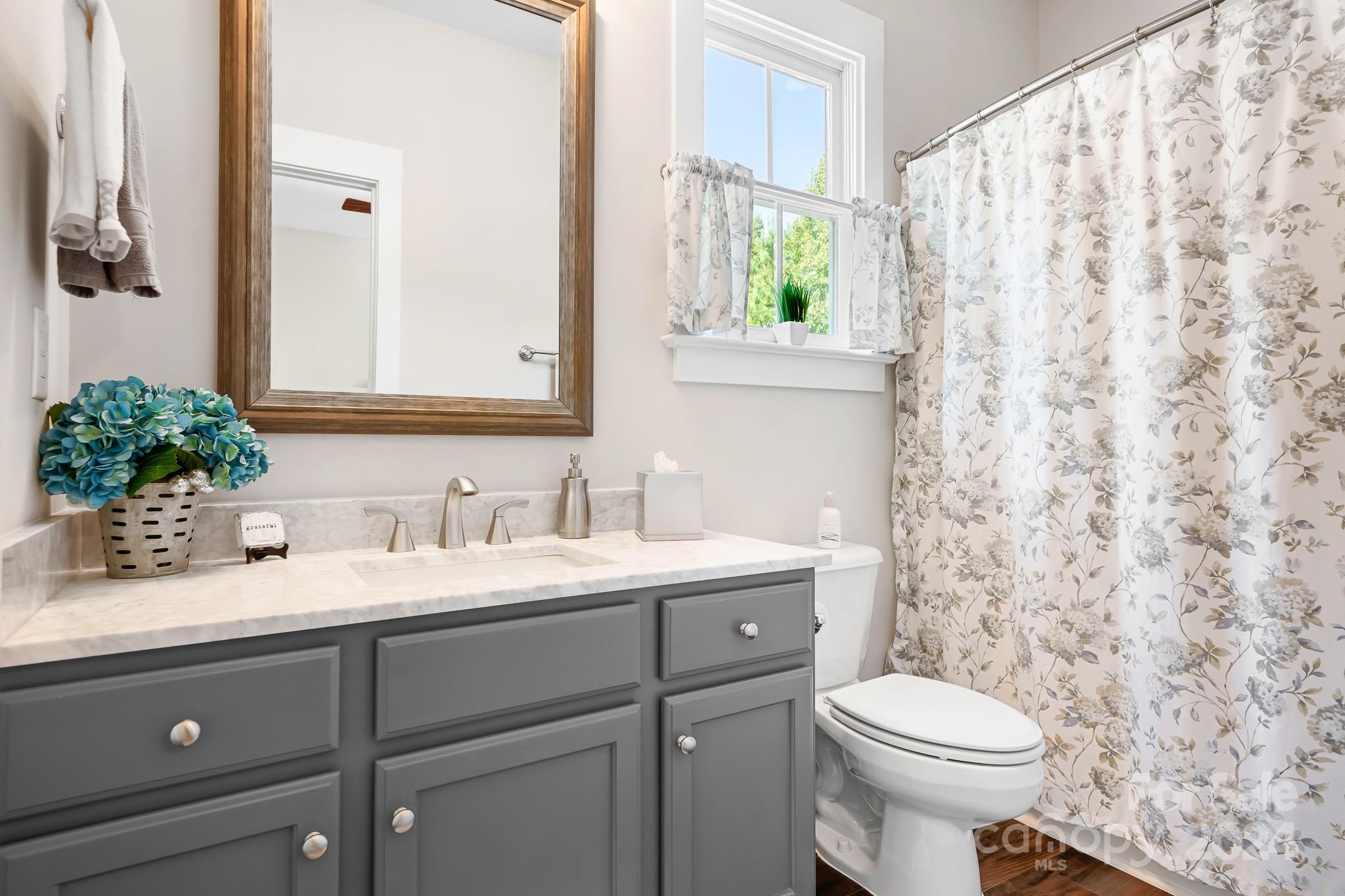 2607 Nations Commons Street Fort Mill, SC 29708 - Photo 19 of 40 a bathroom with a granite countertop sink mirror and toilet