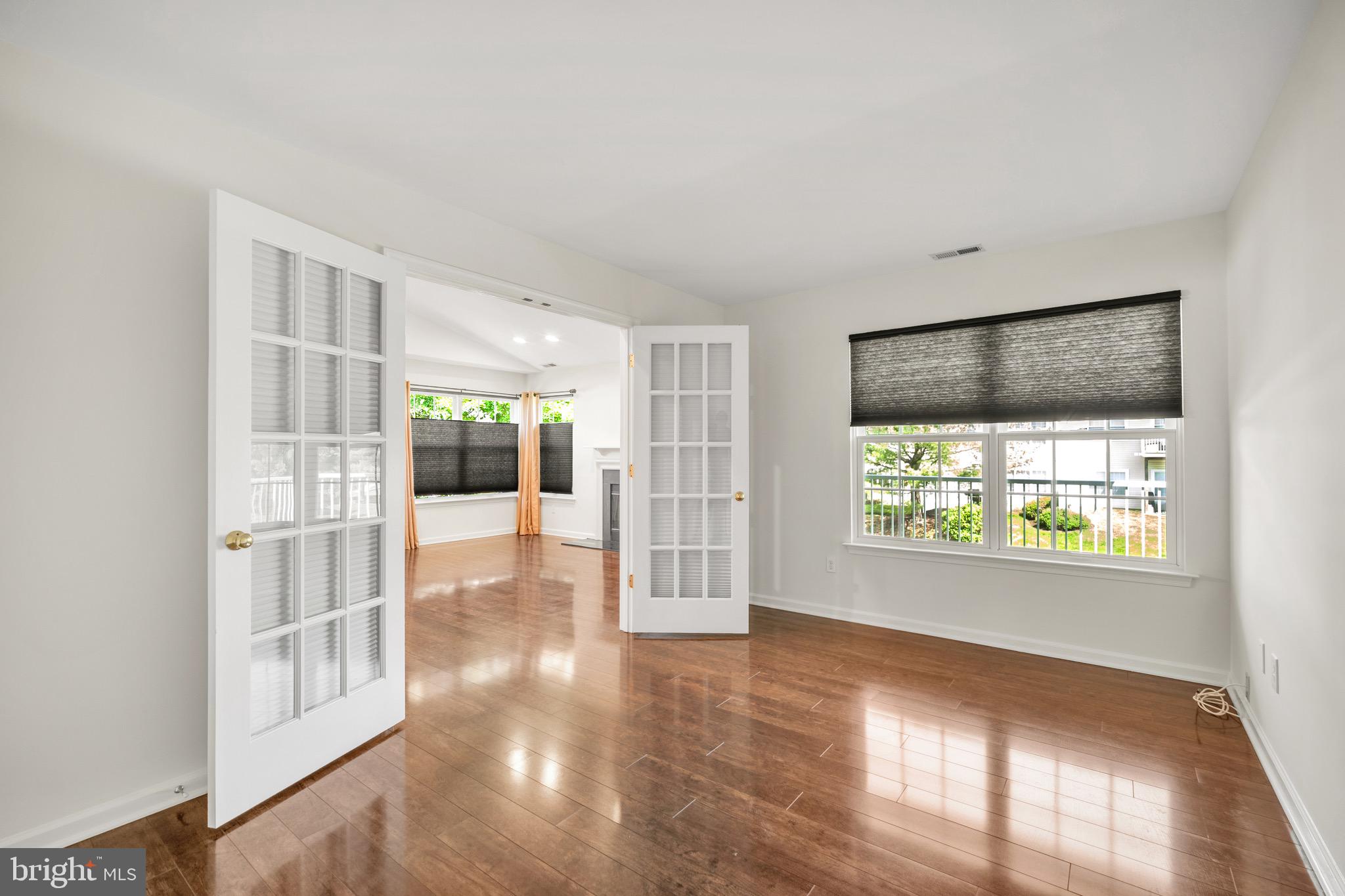 2402 Waterford Road, Unit 94 Yardley, PA 19067 - Photo 23 of 28 a view of an empty room with wooden floor and a window