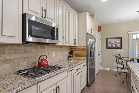 a spacious bathroom with a double vanity sink a mirror and a shower