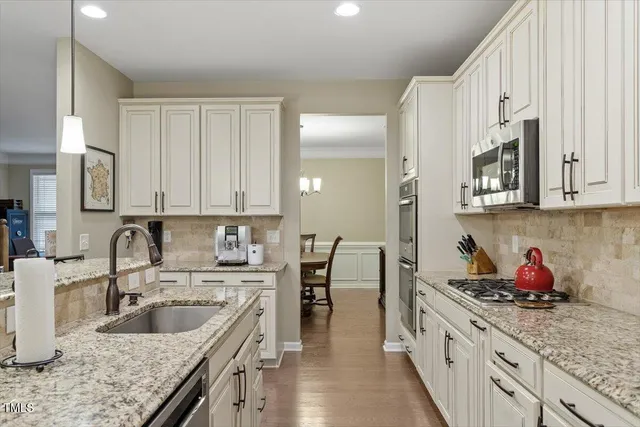 a spacious bedroom with a bed a chandelier and a chandelier