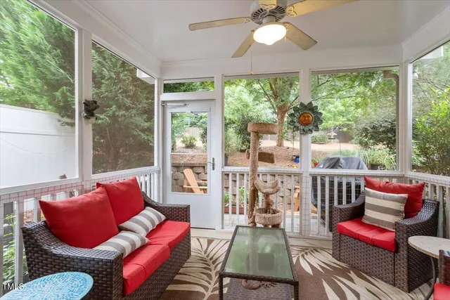 a view of a patio with table and chairs and a large tree