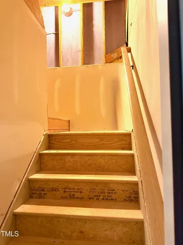 a front view of a house with a yard and potted plants