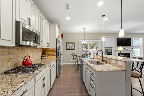 a view of a dining room with furniture large windows and wooden floor