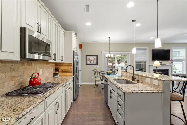 a view of a dining room with furniture large windows and wooden floor