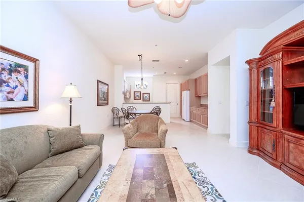 a living room with furniture a dining table and a window