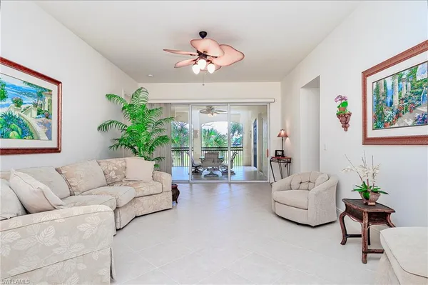 a living room with furniture kitchen and a chandelier