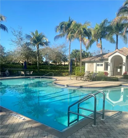 a view of swimming pool with a garden and patio