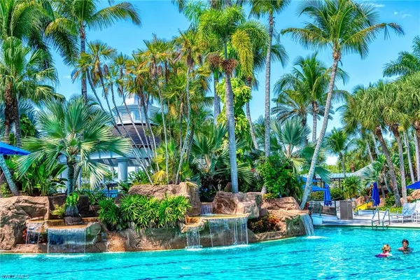 a lawn chairs sitting in a yard with palm trees
