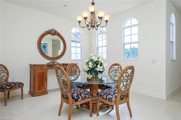 a dining room with furniture and a mirror