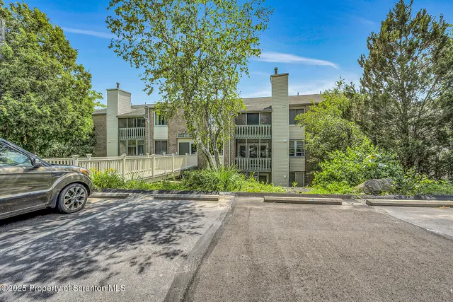 a view of a house with a yard and garage