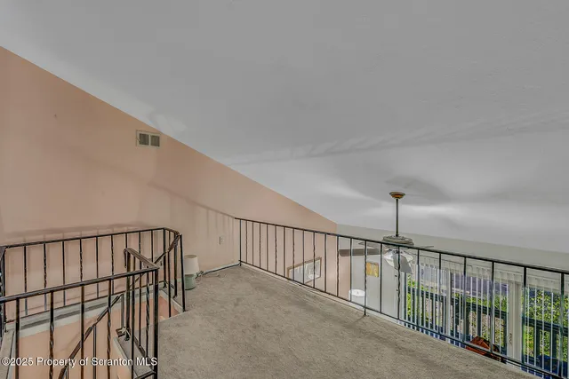 a view of staircase with white walls