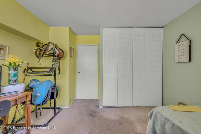 a view of a bedroom with bed and furniture