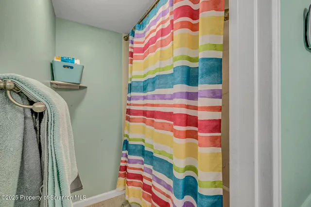 a bathroom with a bathtub and shower curtain