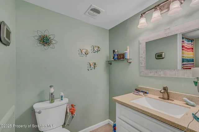 a bathroom with a sink mirror and toilet