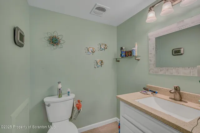 a bathroom with a sink mirror and toilet