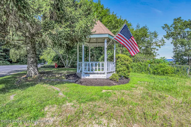 a view of a house with a yard and sitting area