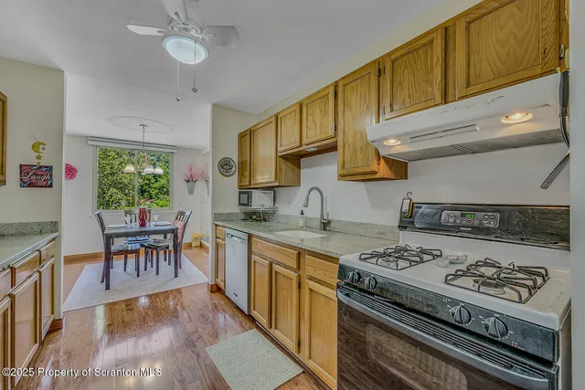 a kitchen with a stove a sink and cabinets