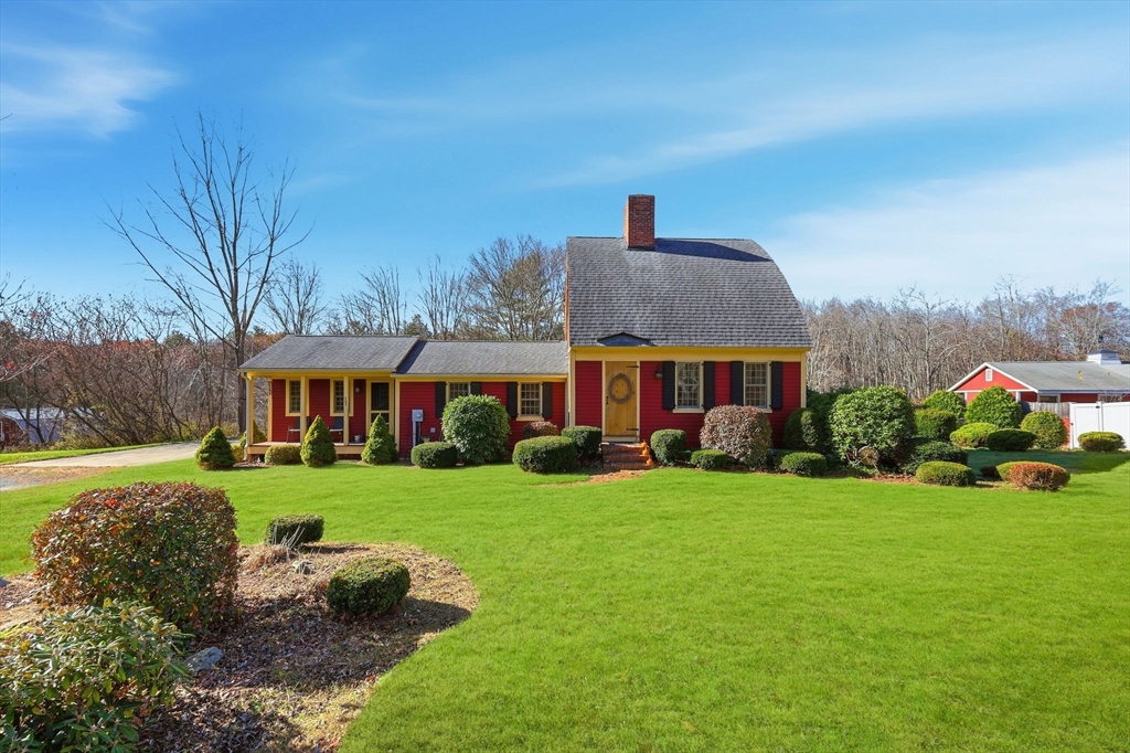 a front view of a house with garden