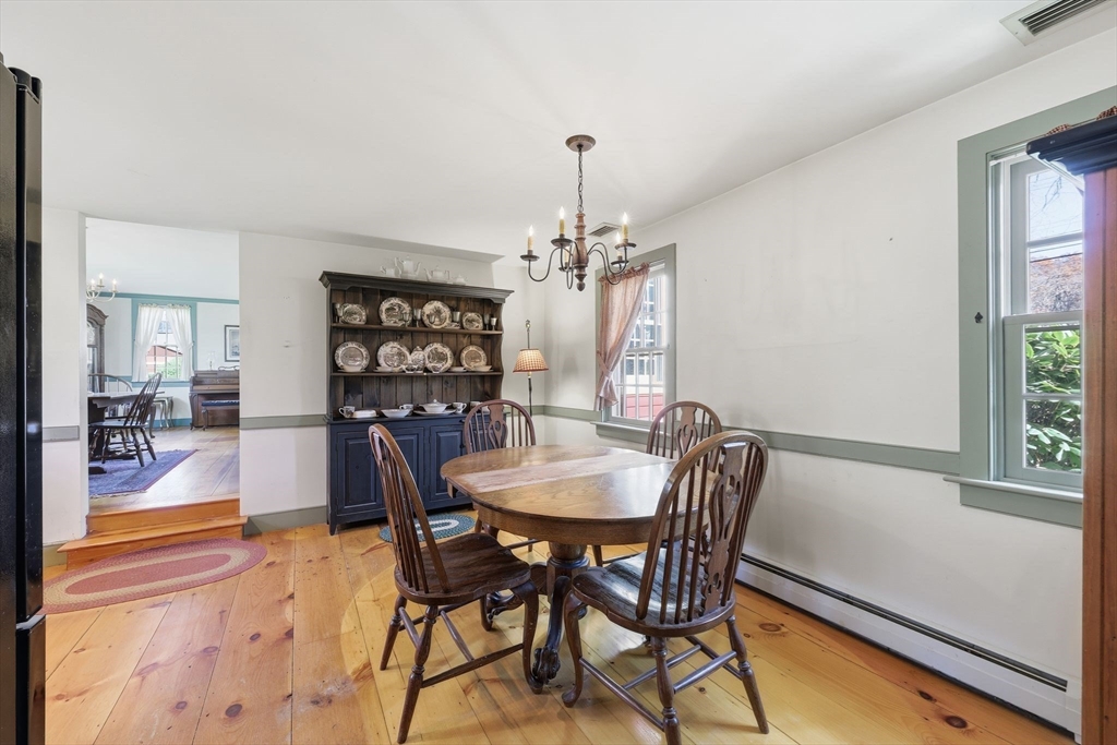 405 Rock Valley Road Holyoke, MA 01040 - Photo 17 of 42 a dining room with furniture a chandelier and wooden floor