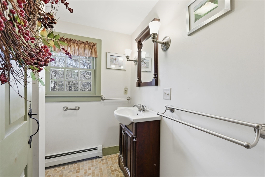 405 Rock Valley Road Holyoke, MA 01040 - Photo 22 of 42 a bathroom with a sink mirror and a shower