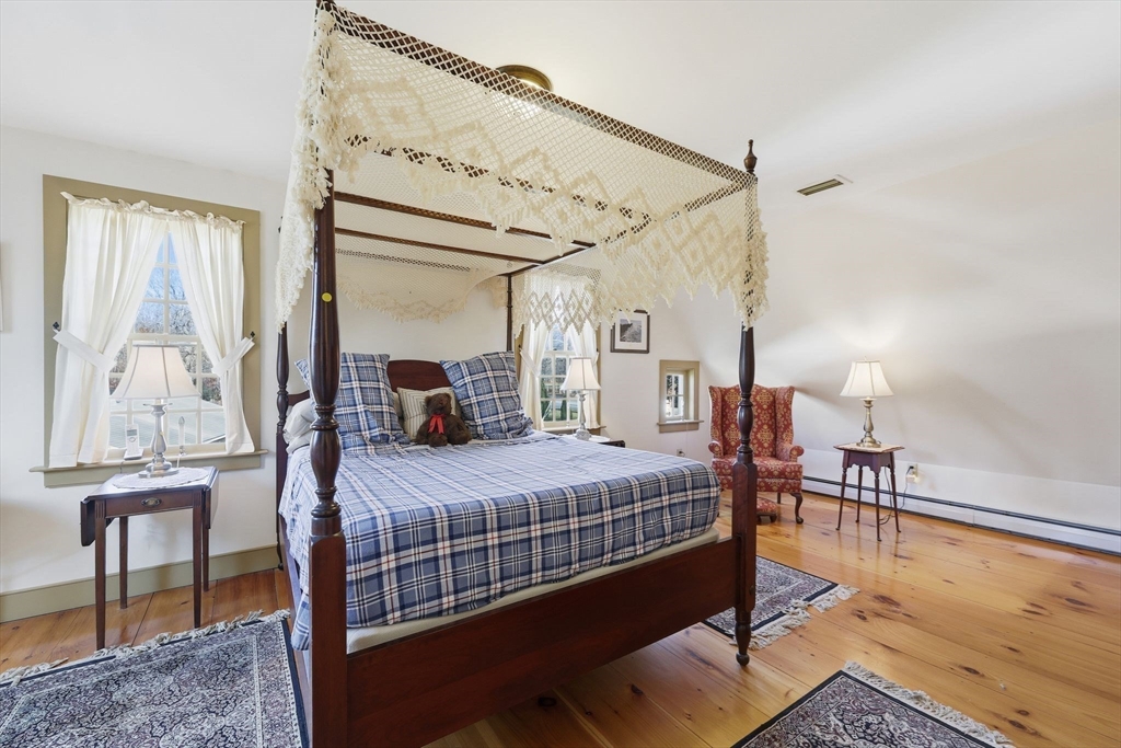 405 Rock Valley Road Holyoke, MA 01040 - Photo 24 of 42 a bedroom with a bed and wooden floor