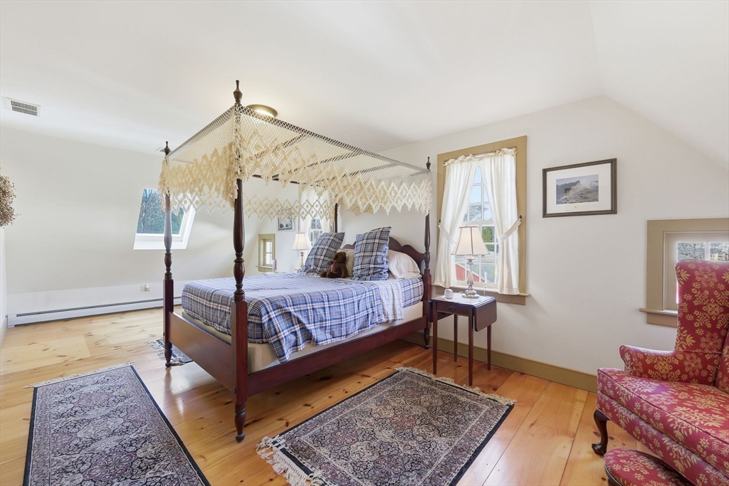 405 Rock Valley Road Holyoke, MA 01040 - Photo 25 of 42 a bedroom with a bed rug and wooden floor