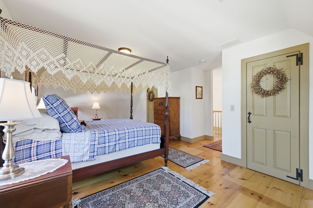 405 Rock Valley Road Holyoke, MA 01040 - Photo 26 of 42 a bedroom with bed and wooden floor