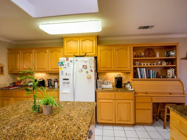 a kitchen with refrigerator and window