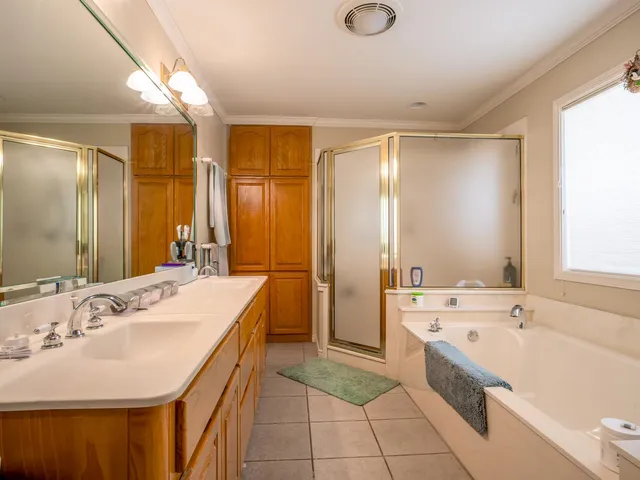 a bathroom with a tub sink and mirror