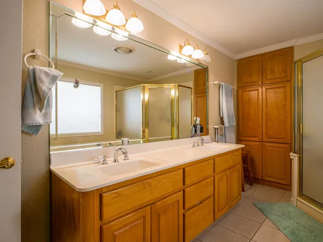 a bathroom with a sink double vanity and a mirror