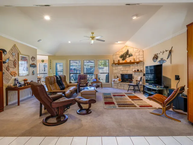 a living room with furniture a flat screen tv and a fireplace