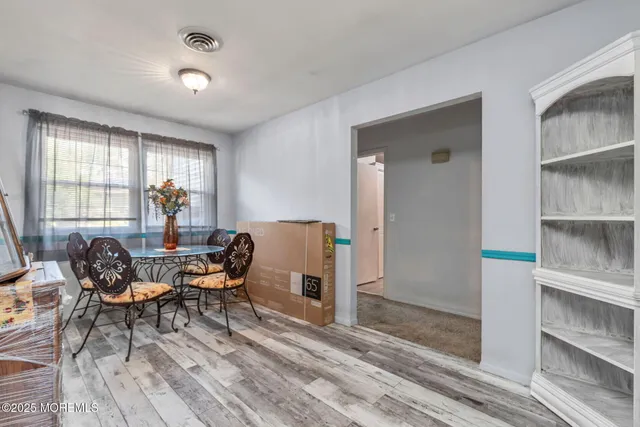 a dining room with furniture and window