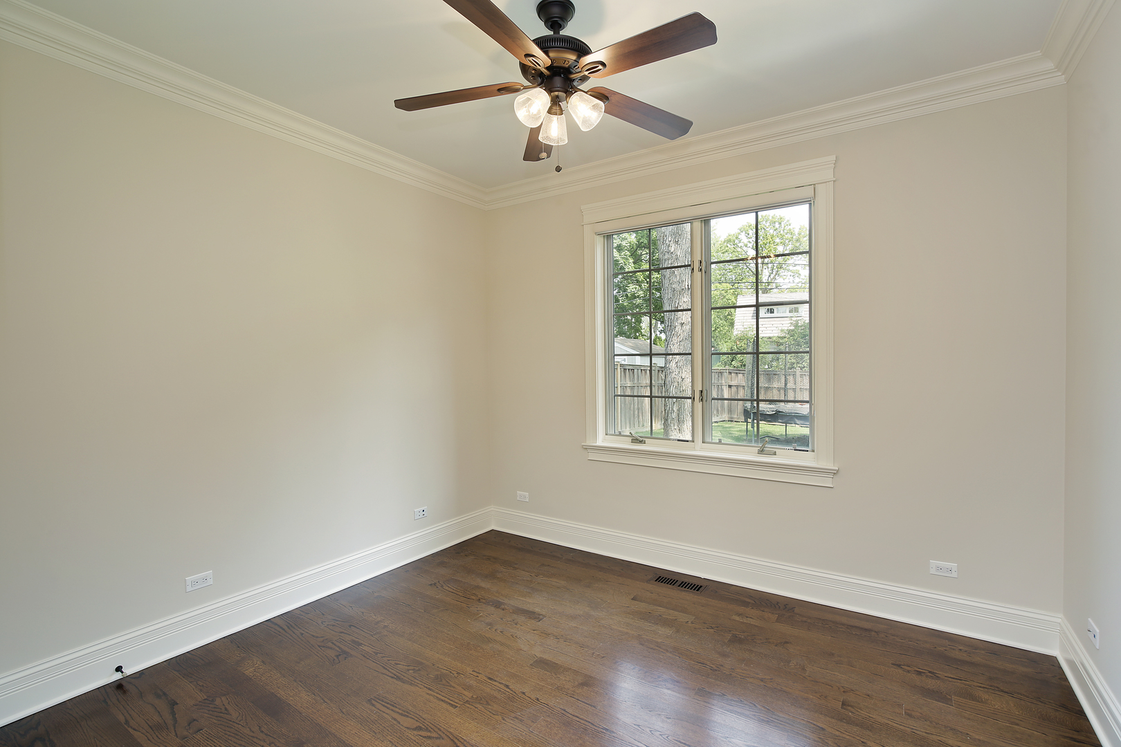 2215 Pinehurst Drive Glenview, IL 60025 - Photo 11 of 31 an empty room with wooden floor fan and windows