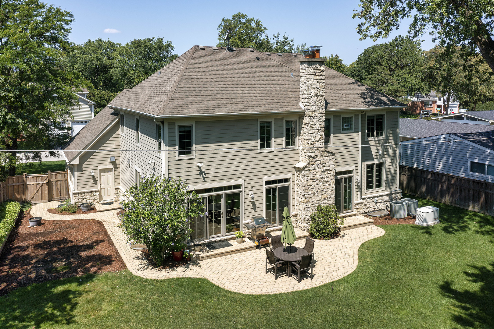 2215 Pinehurst Drive Glenview, IL 60025 - Photo 26 of 31 a view of a house with a yard fire pit and outdoor seating
