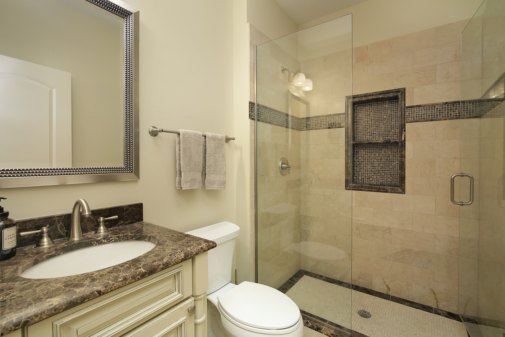 2215 Pinehurst Drive Glenview, IL 60025 - Photo 10 of 31 a bathroom with a granite countertop sink toilet a mirror and shower