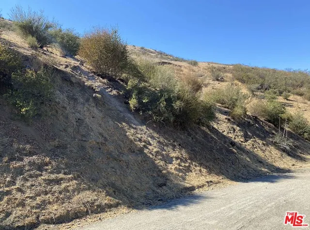 a view of a road with mountains in the background