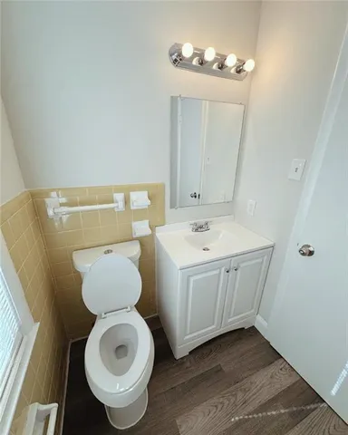 a bathroom with a toilet sink and mirror