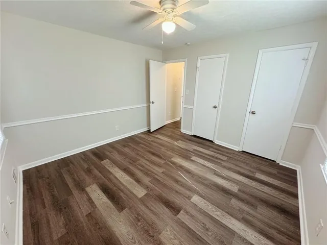 a view of empty room with wooden floor and fireplace