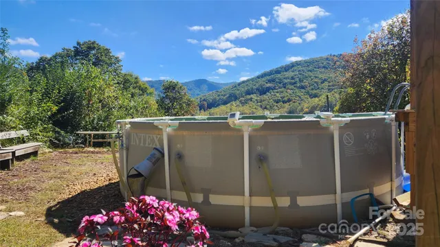 a view of a backyard with tub and entertaining space