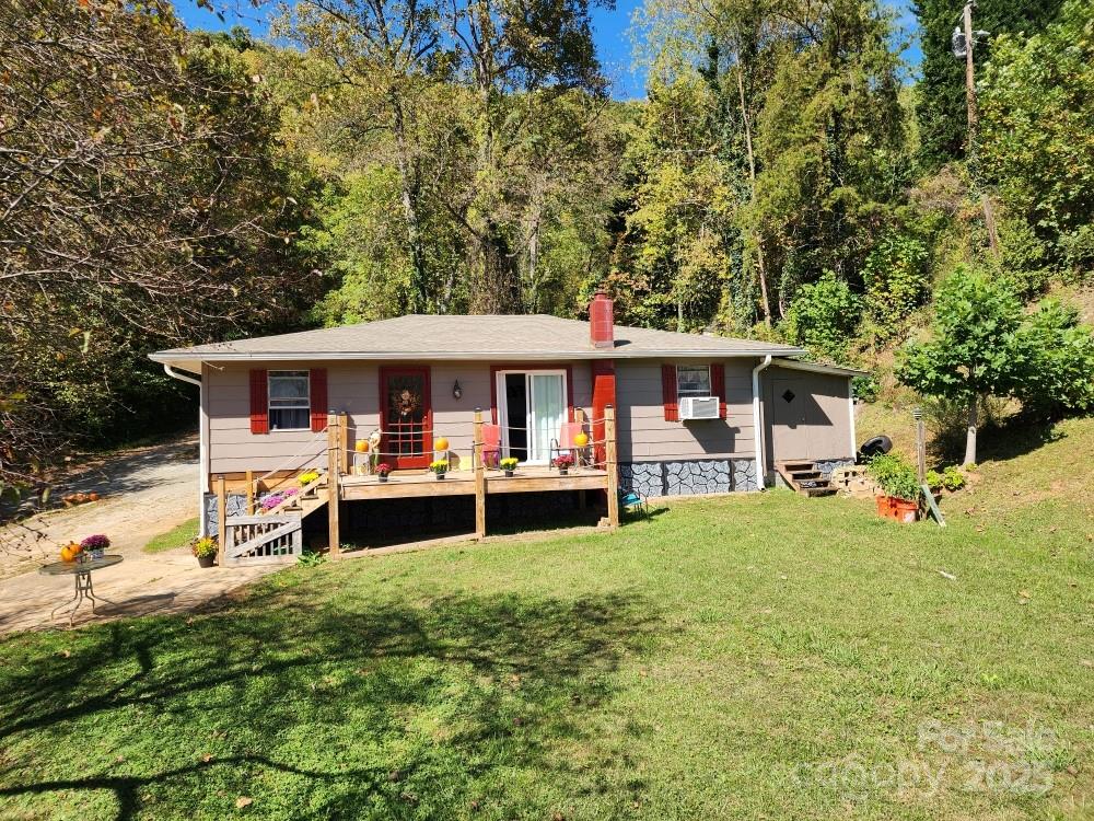 41 Gunches Dirt Road Candler, NC 28715 - Photo 2 of 33 a view of a house with a yard porch and sitting area