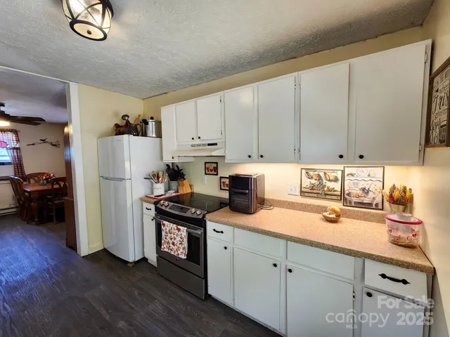 a kitchen with stainless steel appliances a refrigerator sink and cabinets