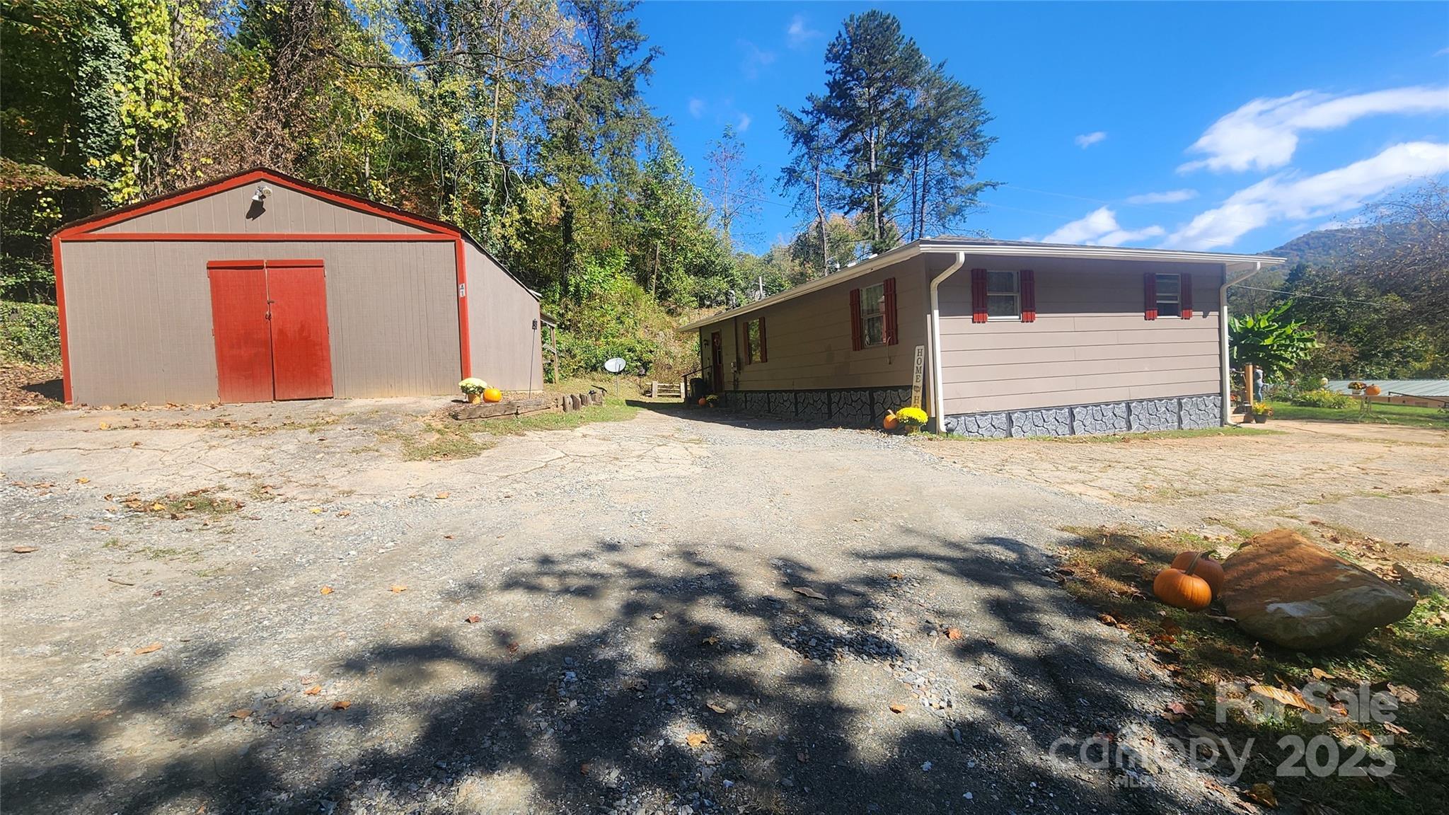 41 Gunches Dirt Road Candler, NC 28715 - Photo 7 of 33 a front view of a house with a yard and garage