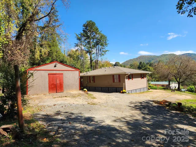 a large house with a large tree in front of it