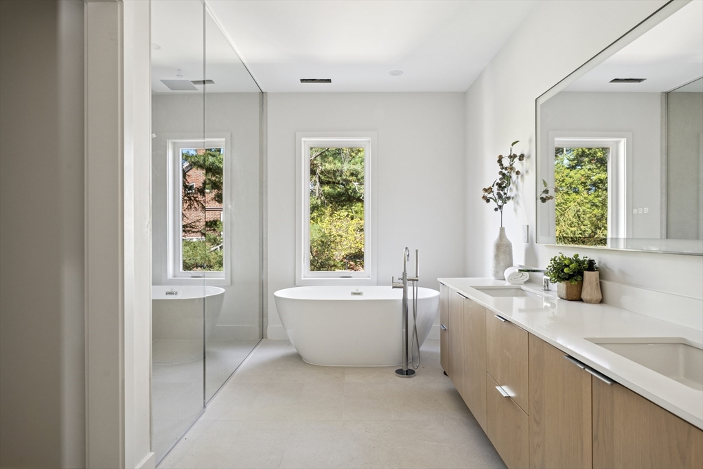 873 Chestnut Street Newton, MA 02468 - Photo 19 of 22 a bathroom with a granite countertop tub sink and mirror