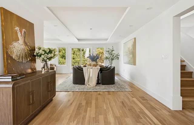 a living room with a large window and furniture